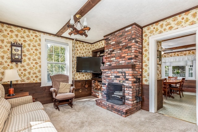 carpeted living room featuring ornamental molding, a textured ceiling, a fireplace, and wooden walls