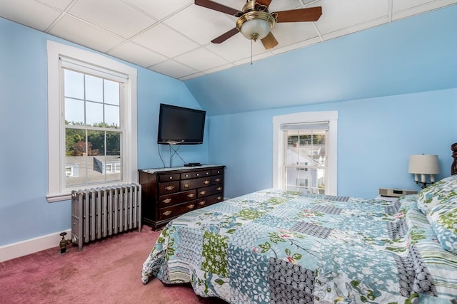 carpeted bedroom featuring ceiling fan, radiator, lofted ceiling, and a paneled ceiling