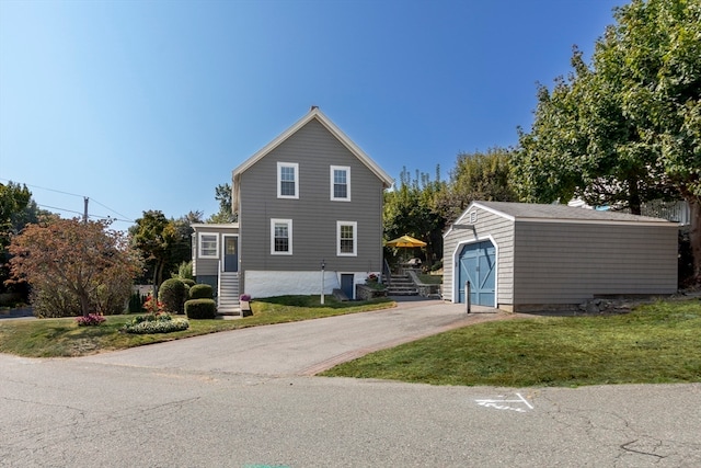 front facade with a front yard and an outbuilding