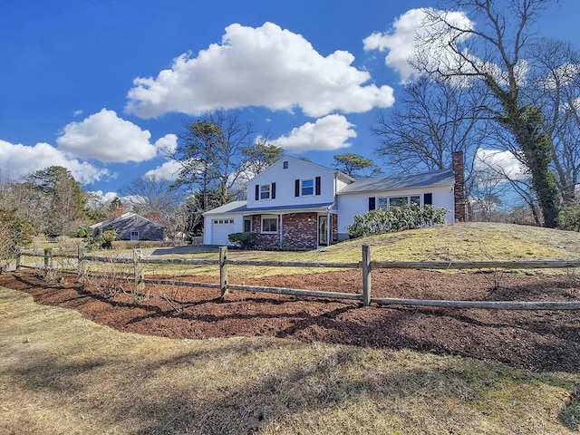 11 Great Oak Rd, Brewster, MA 02631 - view of front facade featuring a chimney, driveway, fence, and a front lawn