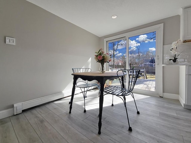 11 Great Oak Rd, Brewster, MA 02631 - dining area with baseboards, light wood-style flooring, and a baseboard heating unit
