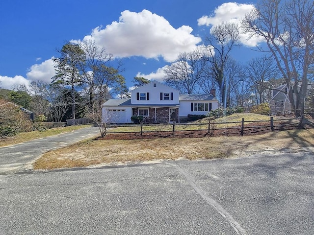 11 Great Oak Rd, Brewster, MA 02631 - view of front facade featuring driveway, a fenced front yard, an attached garage, and a chimney
