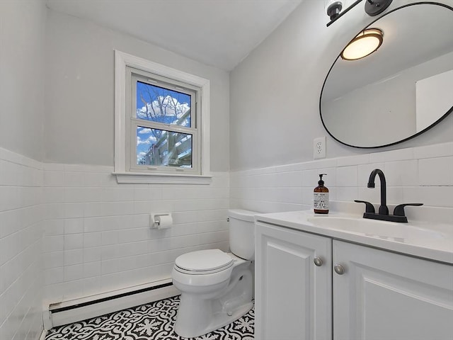11 Great Oak Rd, Brewster, MA 02631 - half bathroom with vanity, tile walls, a baseboard heating unit, toilet, and wainscoting