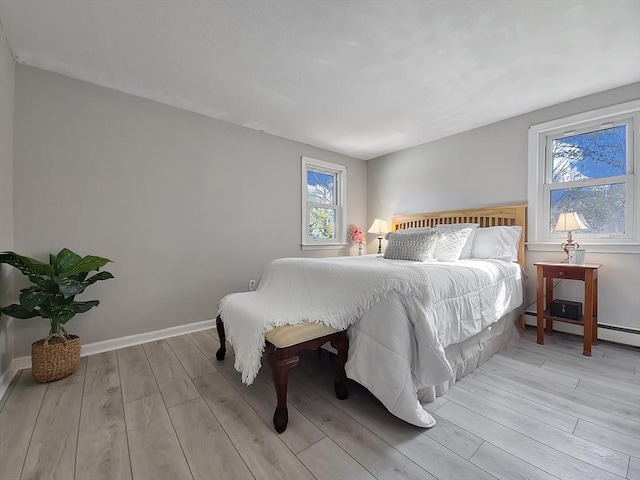 11 Great Oak Rd, Brewster, MA 02631 - bedroom featuring baseboards, a baseboard radiator, and light wood-style floors