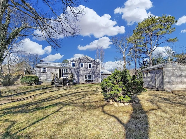 11 Great Oak Rd, Brewster, MA 02631 - back of property featuring a lawn, a wooden deck, an outdoor structure, and a storage shed
