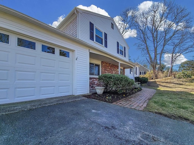 11 Great Oak Rd, Brewster, MA 02631 - view of property exterior featuring brick siding, aphalt driveway, and an attached garage