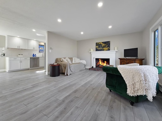 11 Great Oak Rd, Brewster, MA 02631 - living room with baseboards, a fireplace, light wood-style flooring, and recessed lighting