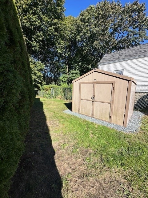 view of outbuilding featuring a yard