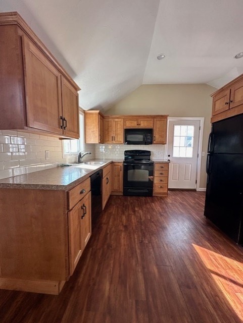 kitchen with dark wood-type flooring, sink, tasteful backsplash, lofted ceiling, and black appliances