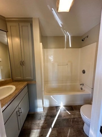 full bathroom featuring vanity, toilet, and shower / bathtub combination