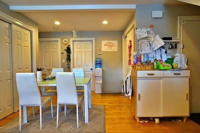 dining room with light wood-style flooring and recessed lighting