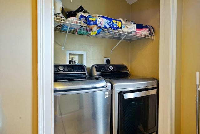 clothes washing area featuring independent washer and dryer