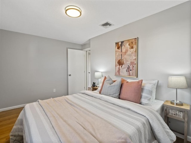 bedroom with hardwood / wood-style flooring