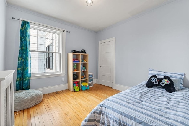 bedroom with baseboards, wood-type flooring, and multiple windows