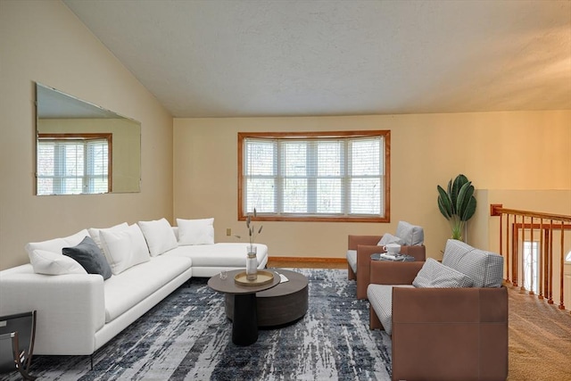 carpeted living room featuring lofted ceiling and a wealth of natural light