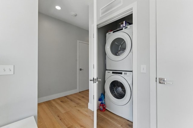 191 Washington St Unit 524, Boston, MA 02135 - laundry area with estacked washer and dryer and light wood-type flooring