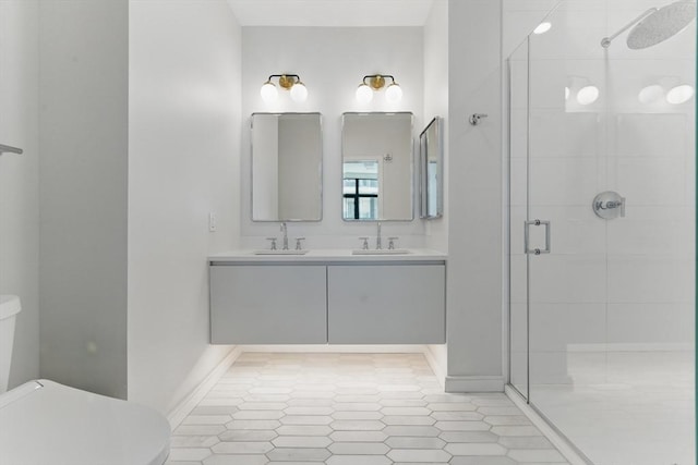 191 Washington St Unit 524, Boston, MA 02135 - bathroom featuring a stall shower, toilet, double vanity, and tile patterned flooring