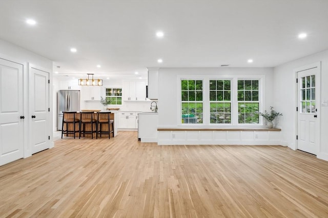 22 Longhill Rd, Ashland, MA 01721 - unfurnished living room featuring a sink, light wood finished floors, recessed lighting, and plenty of natural light