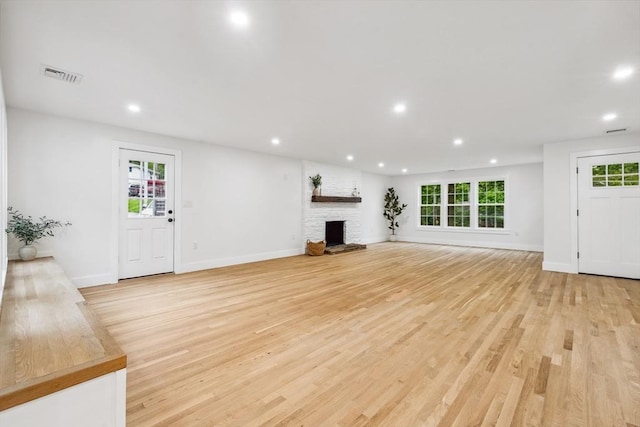 22 Longhill Rd, Ashland, MA 01721 - unfurnished living room with recessed lighting, light wood finished floors, plenty of natural light, and a stone fireplace