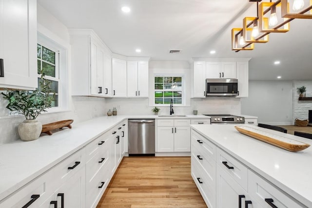22 Longhill Rd, Ashland, MA 01721 - kitchen with stainless steel appliances, a sink, recessed lighting, healthy amount of natural light, and white cabinets