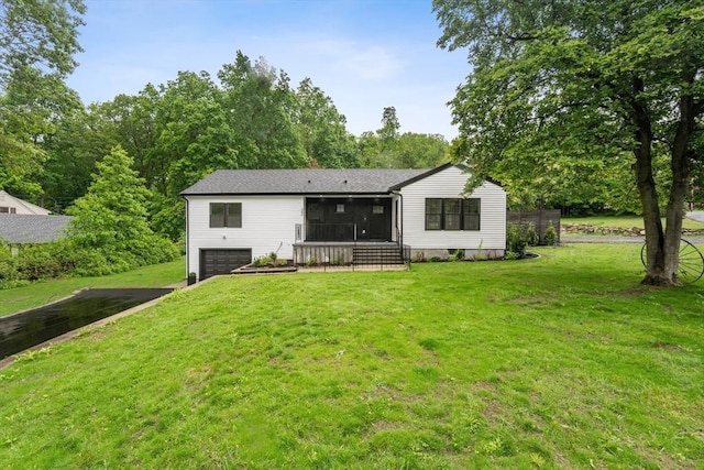 22 Longhill Rd, Ashland, MA 01721 - back of house with an attached garage, asphalt driveway, a sunroom, and a yard
