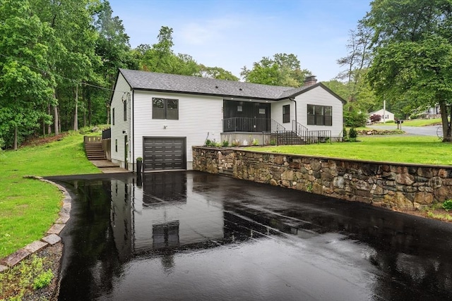 22 Longhill Rd, Ashland, MA 01721 - view of front of home featuring a chimney, an attached garage, asphalt driveway, and a front lawn