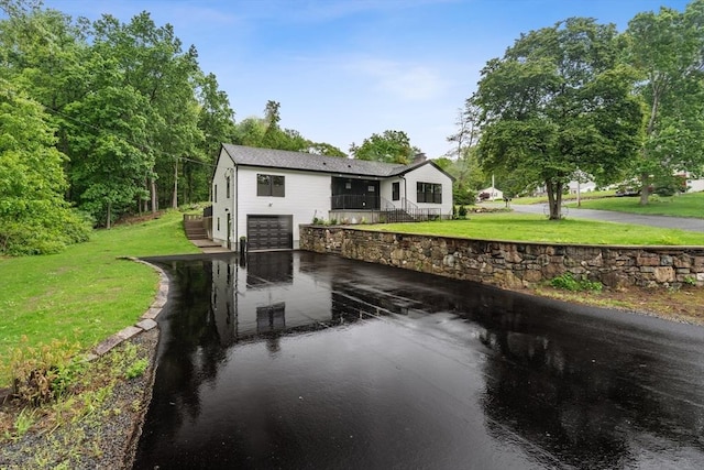 22 Longhill Rd, Ashland, MA 01721 - view of front of home featuring a garage, a front lawn, and driveway
