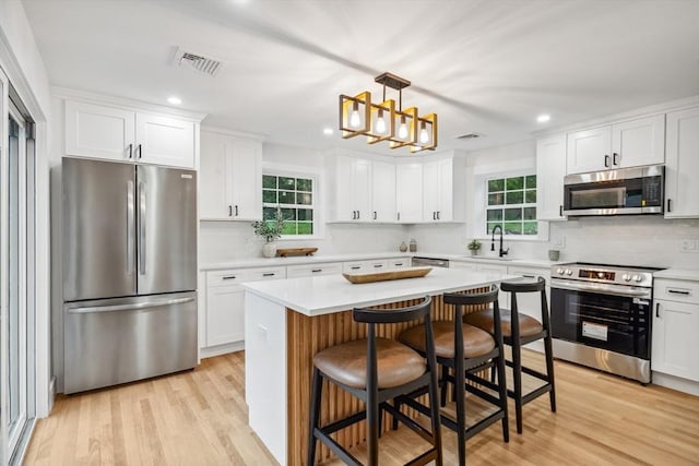 22 Longhill Rd, Ashland, MA 01721 - kitchen with stainless steel appliances, a sink, white cabinetry, backsplash, and recessed lighting