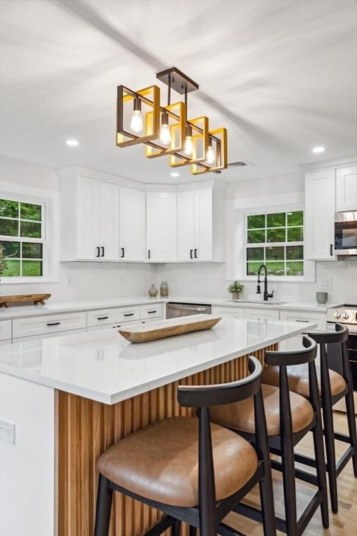 22 Longhill Rd, Ashland, MA 01721 - kitchen featuring stainless steel microwave, electric range, plenty of natural light, white cabinets, and recessed lighting