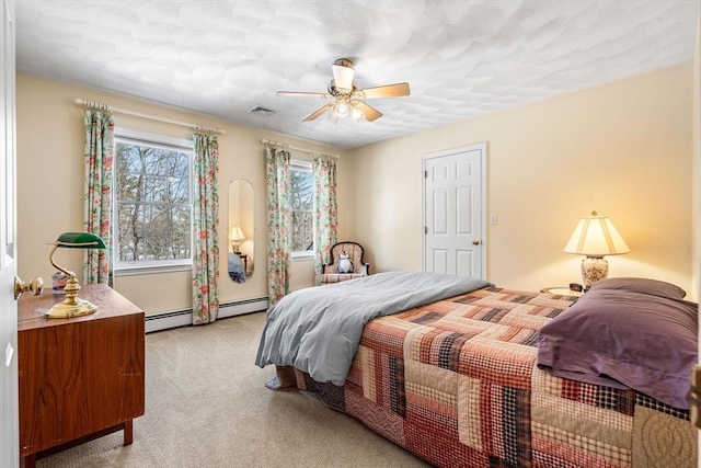 bedroom with light carpet, a baseboard heating unit, visible vents, and a ceiling fan