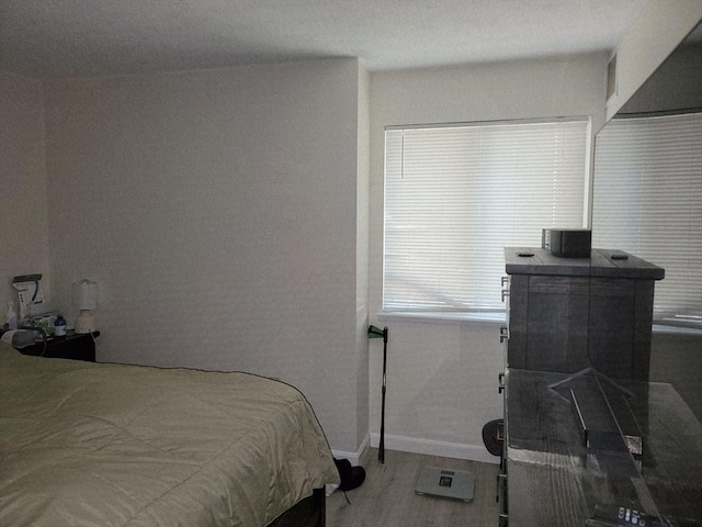 4 Post Oak Ln Unit 15, Natick, MA 01760 - bedroom featuring baseboards and wood finished floors