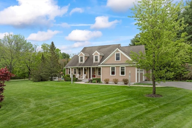 32 Rideout Rd, Hollis, NH 03049 - cape cod-style house with covered porch, driveway, a front yard, and a garage