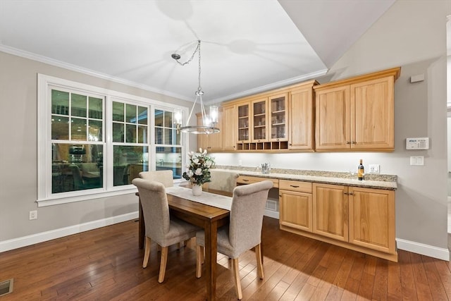 32 Rideout Rd, Hollis, NH 03049 - dining space featuring dark wood finished floors, ornamental molding, and a chandelier