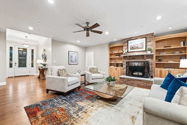 32 Rideout Rd, Hollis, NH 03049 - living area featuring ornamental molding, recessed lighting, ceiling fan, wood finished floors, and a brick fireplace