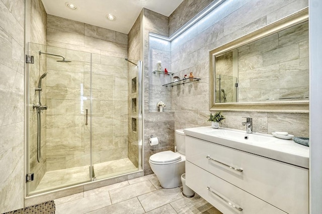 full bath featuring vanity, toilet, tile walls, and a stall shower