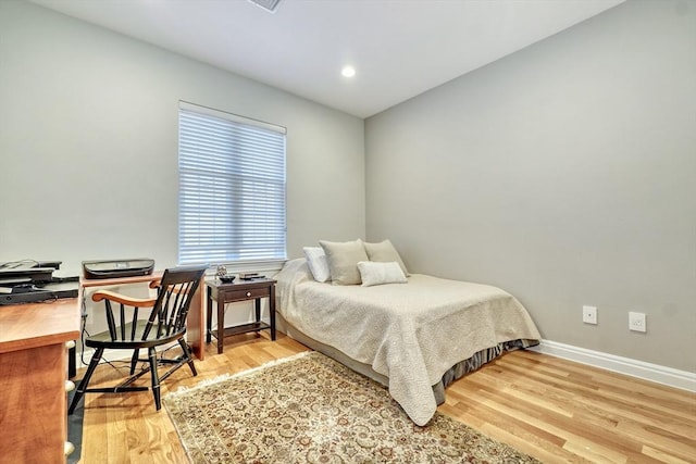 bedroom featuring baseboards, recessed lighting, and wood finished floors