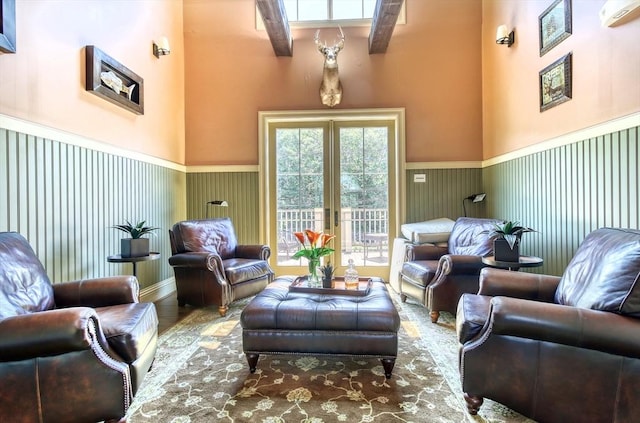 living room with a wainscoted wall and wood finished floors