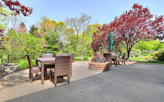 view of patio featuring outdoor dining space and an outdoor fire pit