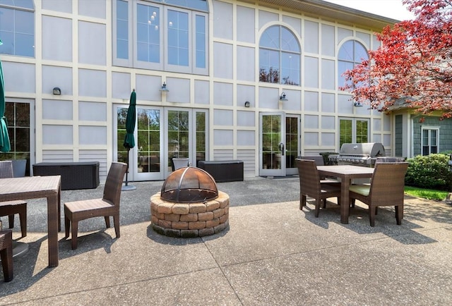 view of patio / terrace featuring grilling area, a fire pit, and outdoor dining space