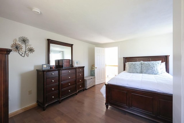 bedroom featuring dark wood finished floors and baseboards