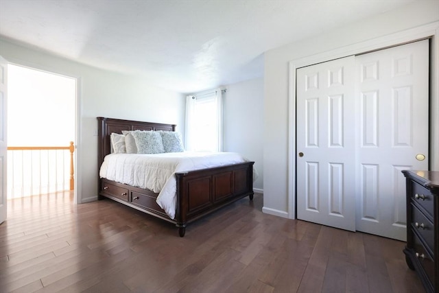 bedroom with dark wood-type flooring and baseboards