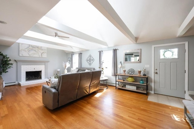 living area with a baseboard radiator, ceiling fan, and plenty of natural light