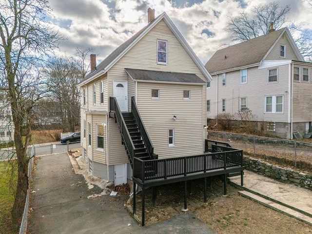 rear view of house with a wooden deck