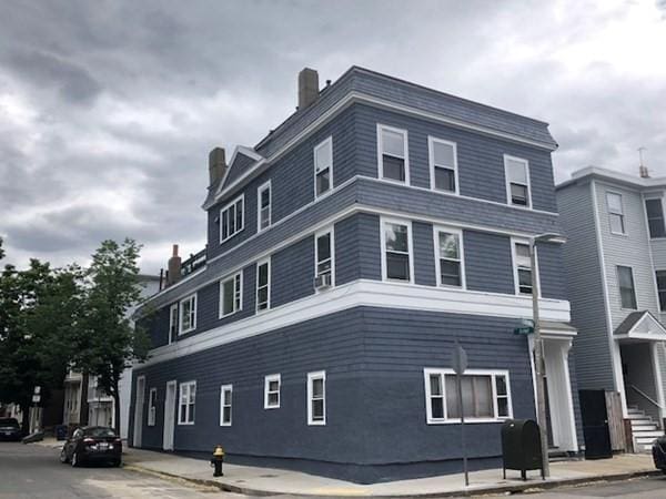view of side of home featuring a chimney