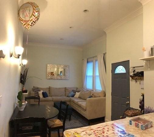 living room with ornamental molding