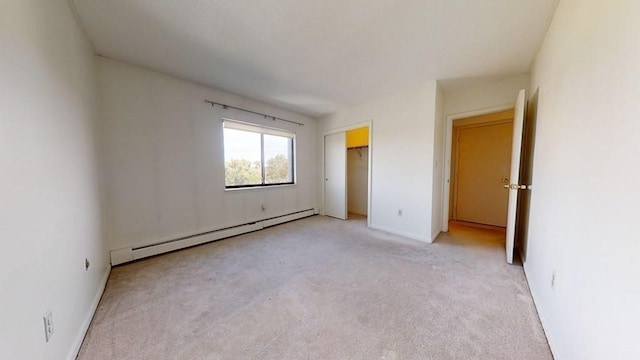 164 Galen St Unit 65, Watertown, MA 02472 - unfurnished bedroom with a baseboard heating unit, light carpet, baseboards, and a closet