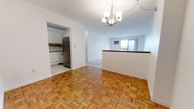 164 Galen St Unit 65, Watertown, MA 02472 - empty room featuring a chandelier and baseboards