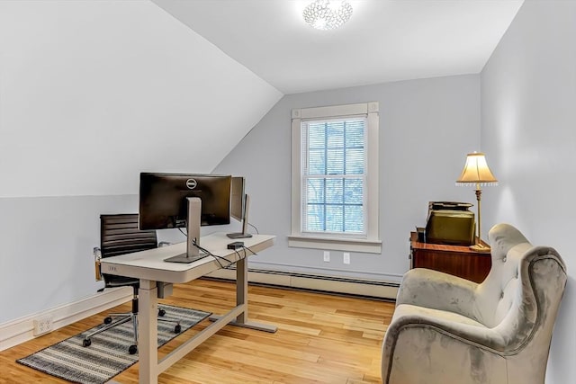 office space featuring a baseboard heating unit, vaulted ceiling, wood finished floors, and baseboards