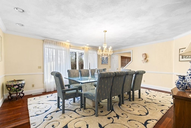 dining area with a textured ceiling, dark wood-type flooring, a chandelier, and crown molding