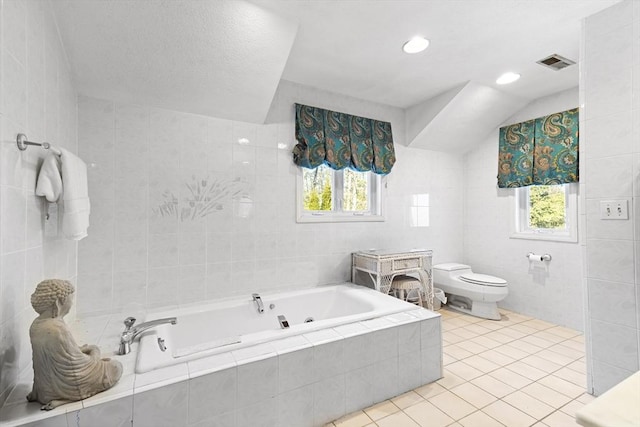 bathroom featuring toilet, tile walls, and tile patterned floors